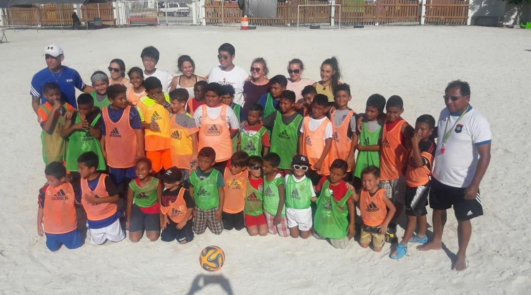 An instructor volunteering as a sports coach in schools in Belize poses with his team A Projects Abroad volunteer gets sports coaching work experience in Belize